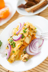 baked potatoes with onions on a white plate