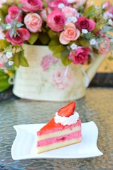 Strawberry cake with flowers on table