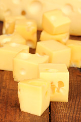 Cheese cubes on wooden table