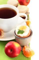 Light breakfast with boiled egg and cup of coffee, isolated