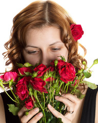 girl smelling roses on a white background isolated