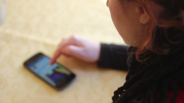 Woman using a smartphone to surf on facebook