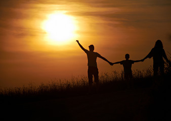 Silhouette happy family  sunset background.