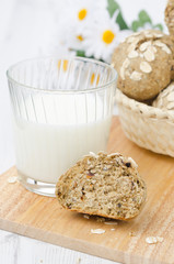 bread rolls wholemeal with oat flakes and a glass of milk