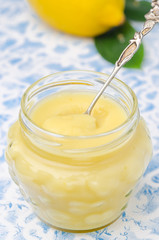 Homemade lemon curd in a glass jar closeup