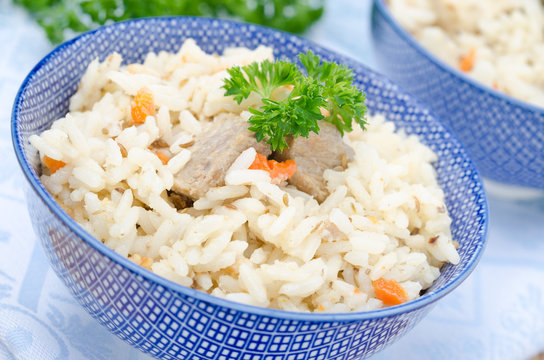 two dowls Uzbek pilaf on the table closeup