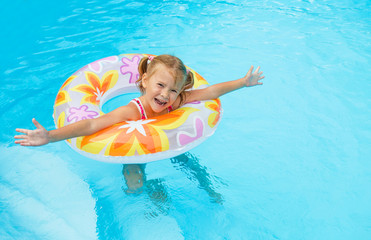 little girl in the pool  with rubber ring