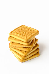 A pile of seven very simple and tasty biscuits to eat, isolated on white background