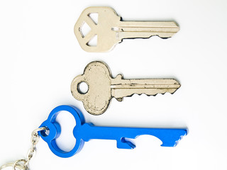 Couple keys and  a blue stainless steel key's keychainisolated o