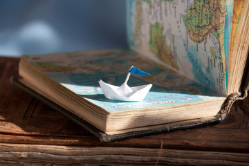 Paper boat and map.