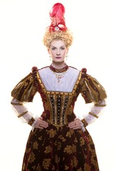 Haughty queen in royal dress isolated on white