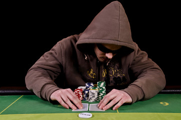 Poker player looks the cards
