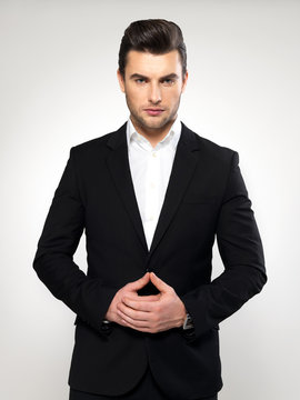 Fashion young businessman in black suit