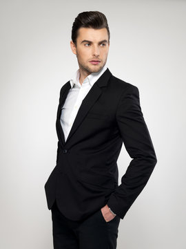 Fashion young businessman in black suit