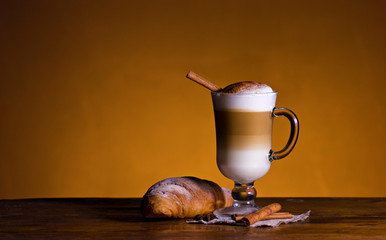 Cappuccino with cinnamon and croissant