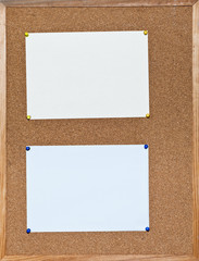 Fototapeta premium two sheets of paper on cork board