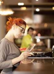 Businesswoman on a coffee break, using tablet computer 