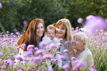 Four generations women in a colorful lavender field