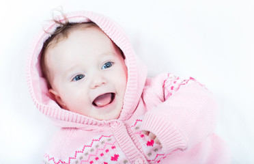 Laughing baby girl knitted pink sweater red hearts