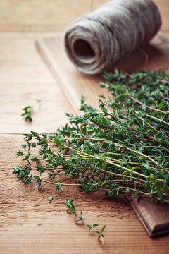 Bunch of fresh thyme on wooden board