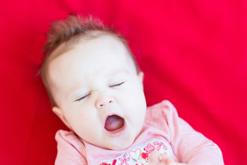 Funny curly baby girl yawning