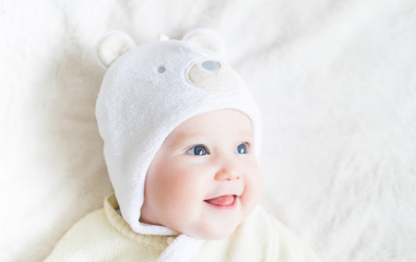 Portrait of a little funny baby in a teddy bear hat