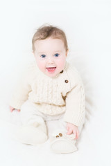 Funny baby in a warm cable knit sweater and boots