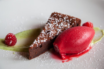 chocolate cake with raspberry sherbet and pistachio cream
