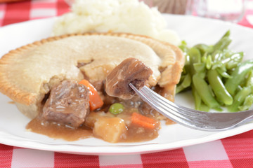 Steak pie on a fork