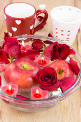 Heart candle with apple and rose petals