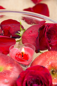 Heart candle with apple and rose petals