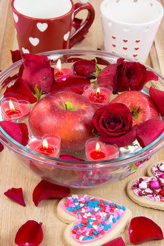 Valentine apple with rose petals and heart candles