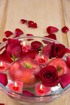 Valentine apple with rose petals and heart candles
