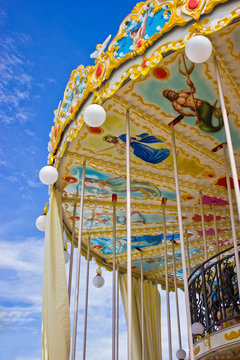 Carousel's ceiling with blue sky.