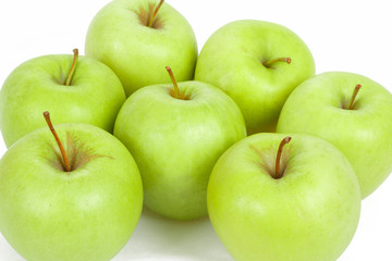 seven green apples isolated on a white background