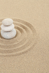 Fototapeta na wymiar balance zen stone in sand with circles
