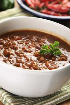 bowl of red hot chili with ground beef, beans and legumes.
