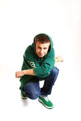 Cool hip hop style dancer sitting isolated on a white background