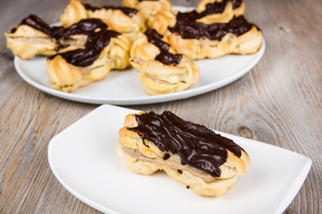 Fresh eclairs with coffee cream inside and chocolate