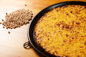 Italian Pizza, ingredients in the background on a wood table