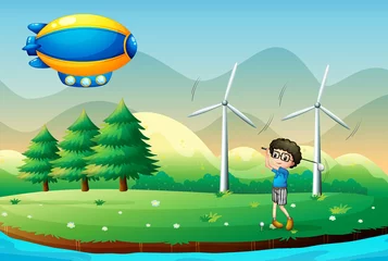  Een jongen die golf speelt in het veld met windmolens © GraphicsRF