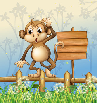 A monkey standing in a fence beside an empty board