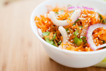 salad of fresh carrots with onions and sesame seeds