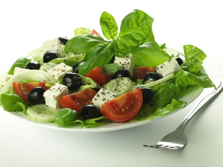 Greek salad with basil leaves