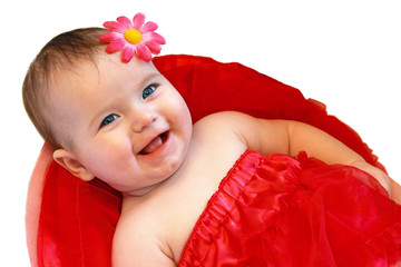 Smiling baby girl dressed in red skirt