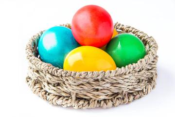 Fototapeta na wymiar Сolored painted eggs in a basket