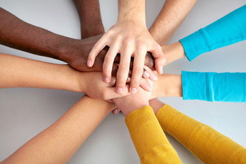 Team of friends showing unity with their hands together