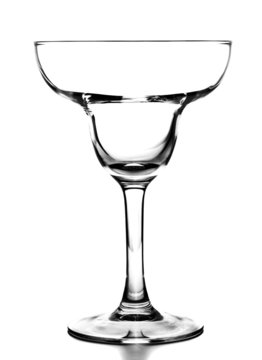 Empty hurricane cocktail glass on white background