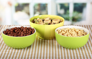 Delicious and healthy cereal in bowls on table in room