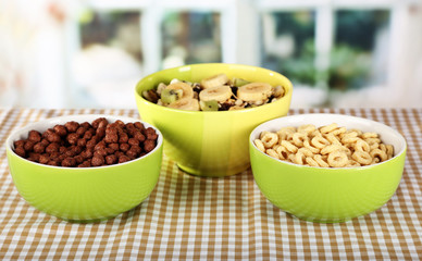 Delicious and healthy cereal in bowls on table in room